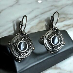 Intricate Vintage Earrings with Dark Stone Centerpiece and Delicate Metalwork